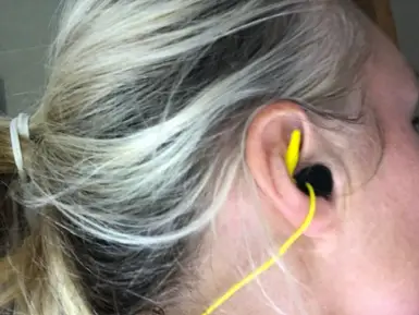 Shows the SwimEars product in the ear